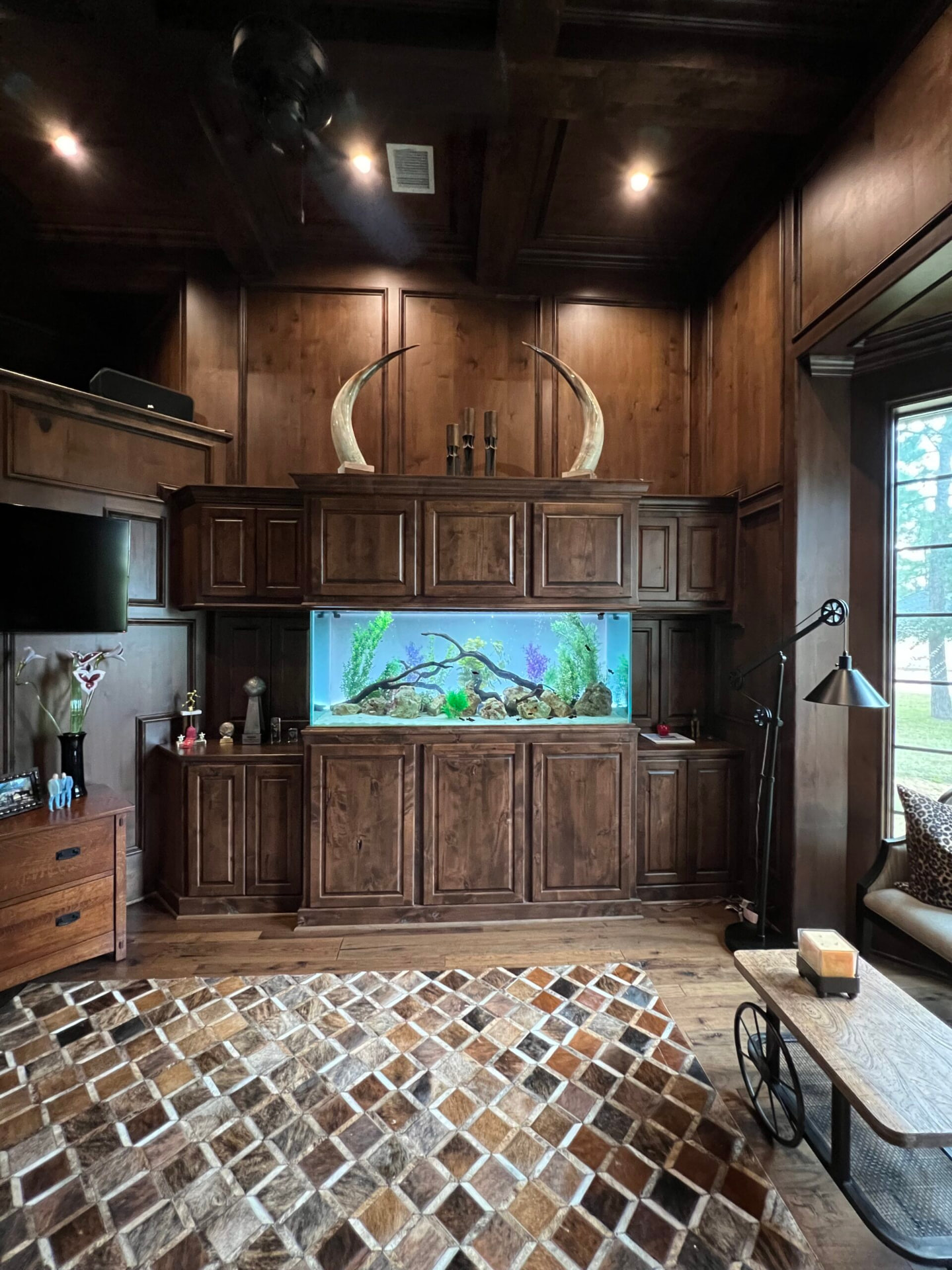 Aquarium built into a wood-paneled study